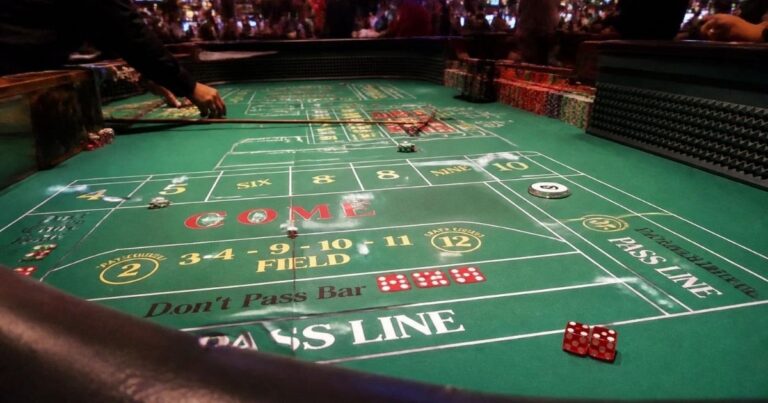 Craps table layout with two dice resting on the pass line