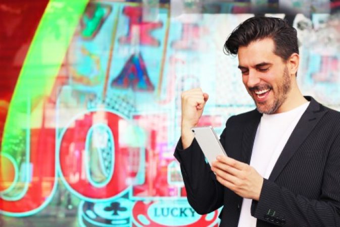 A man feeling jubilant after winning a jackpot on his best gambling app
