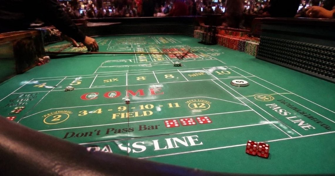 Craps table layout with two dice resting on the pass line